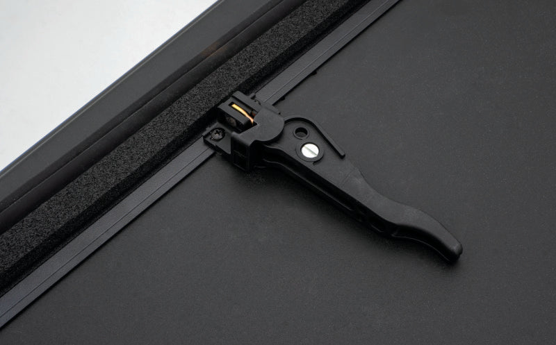 Load image into Gallery viewer, Lund 16-23 Toyota Tacoma (5ft. Bed) Hard Fold Tonneau Cover - Black
