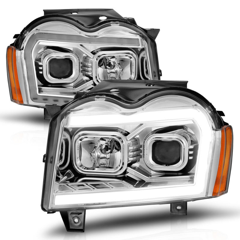 Load image into Gallery viewer, ANZO 05-07 Jeep Grand Cherokee Projector Headlights - w/ Light Bar Switchback Chrome Housing
