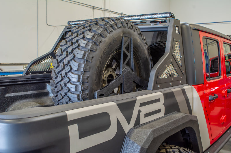 Load image into Gallery viewer, DV8 Offroad 2019+ Jeep Gladiator Universal Stand Up In-Bed Tire Carrier
