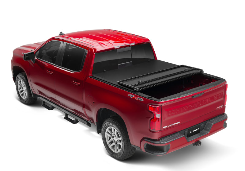 Load image into Gallery viewer, Lund 88-99 Chevy C1500 Fleetside (8ft. Bed) Hard Fold Tonneau Cover - Black
