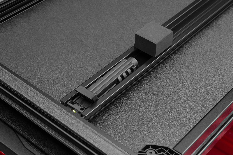 Load image into Gallery viewer, Lund 15-18 Ford F-150 Styleside (5.5ft. Bed) Hard Fold Tonneau Cover - Black

