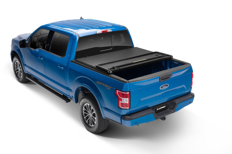 Load image into Gallery viewer, Lund 15-18 Ford F-150 Styleside (5.5ft. Bed) Hard Fold Tonneau Cover - Black
